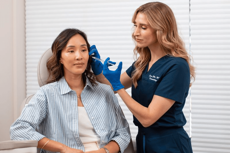 board-certified dermatologist providing botox and fillers to patient 